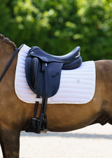 White saddle pad pony dressage